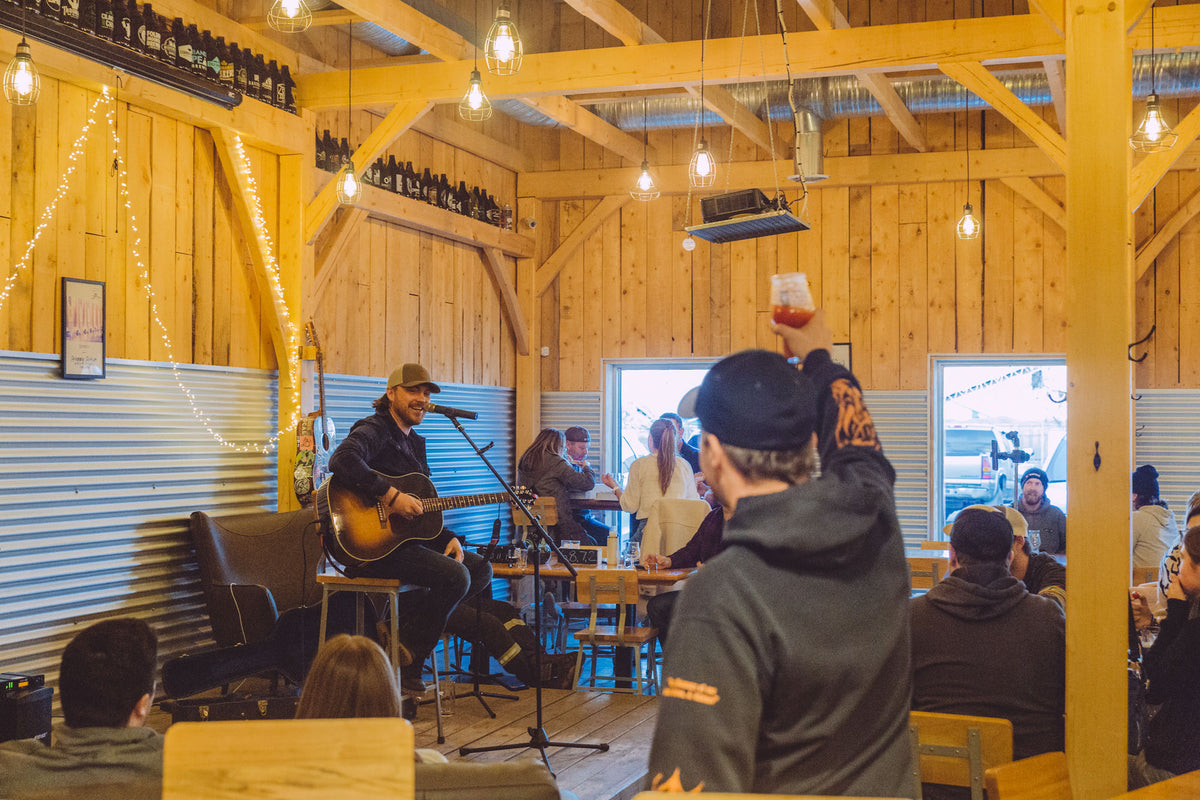 Friends enjoying a gathering at the Snake Lake taproom